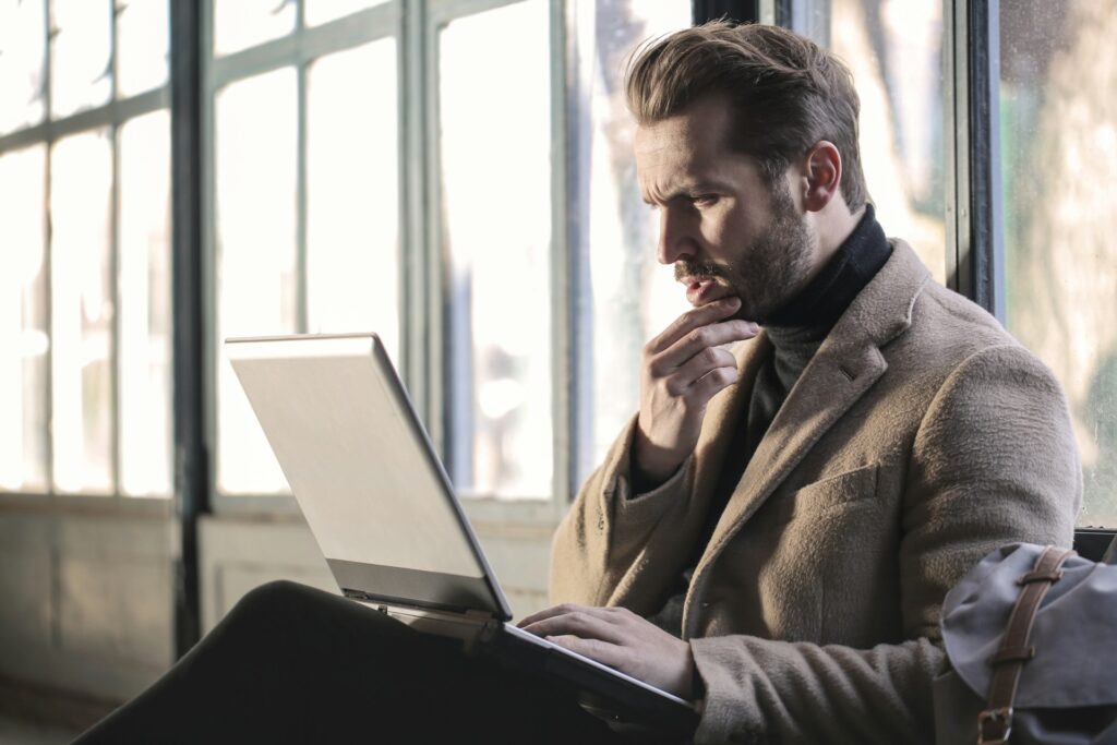 Business owner studying decisions on a laptop