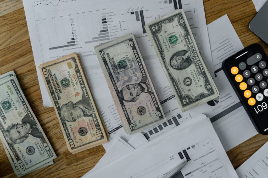 US currency, a calculator, and sales tax reports