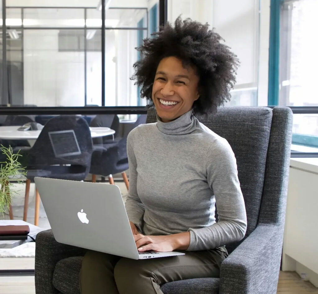 A smiling RJM tax consultant completing an income tax filing for a client