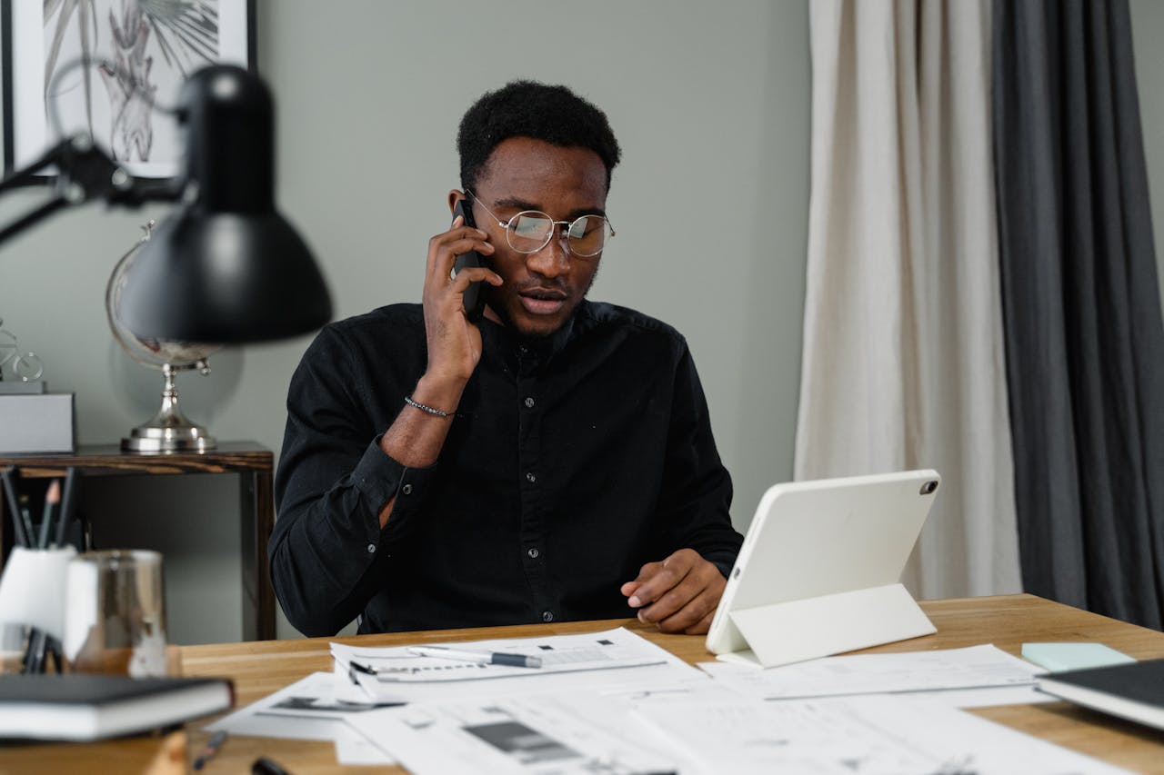 Person talking on the phone, filing taxes