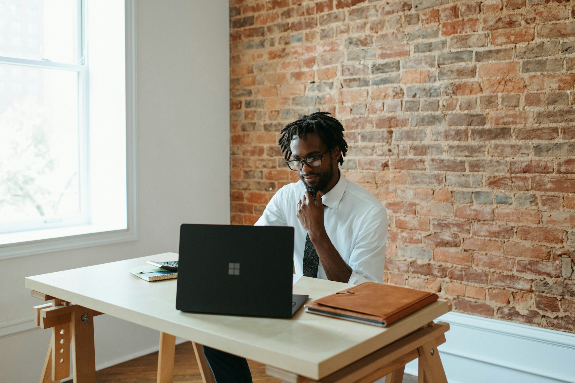 Small Business Owner Preparing Tax Deduction on His Laptop
