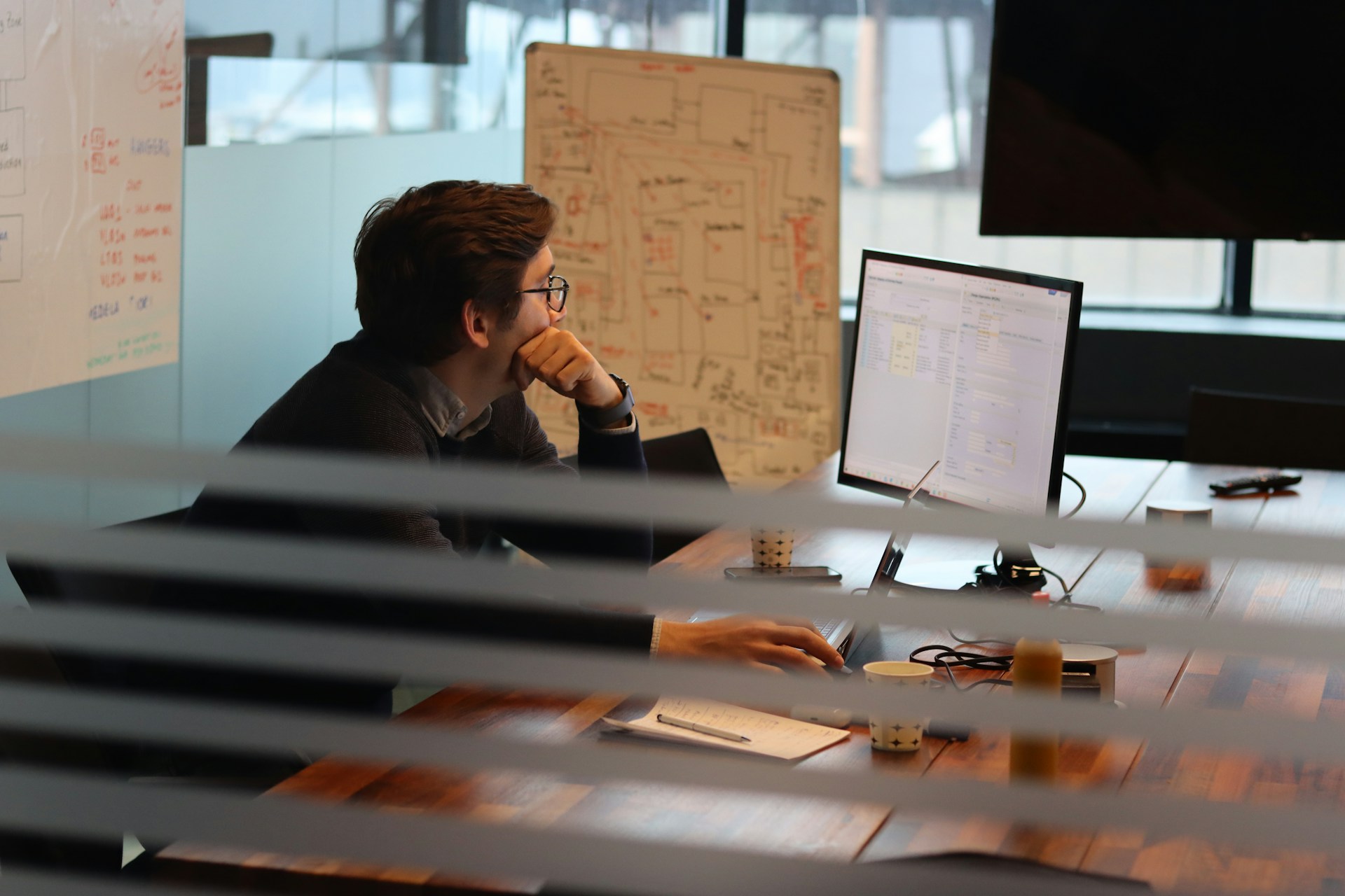 Person looking intently at a monitor in the office