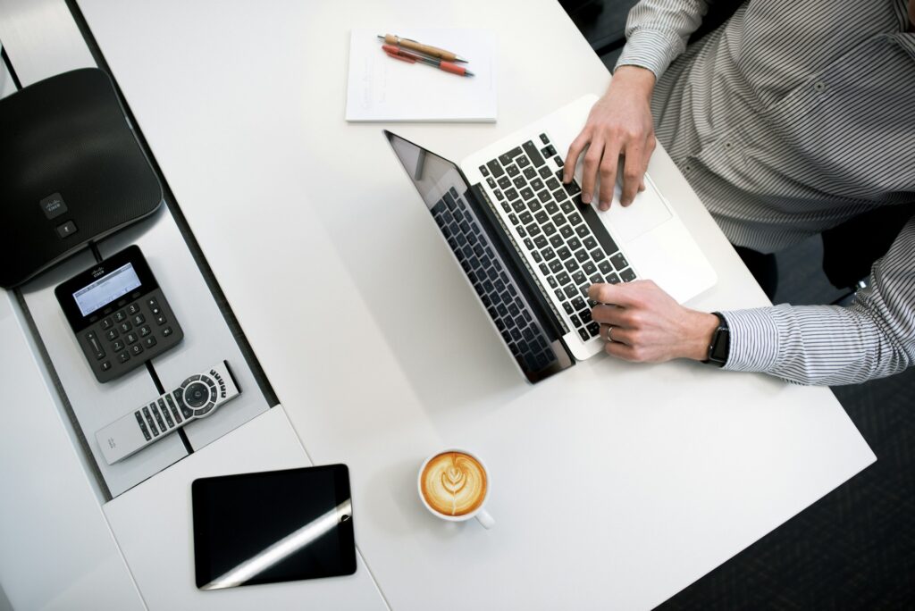 Person working at a desk on their laptop