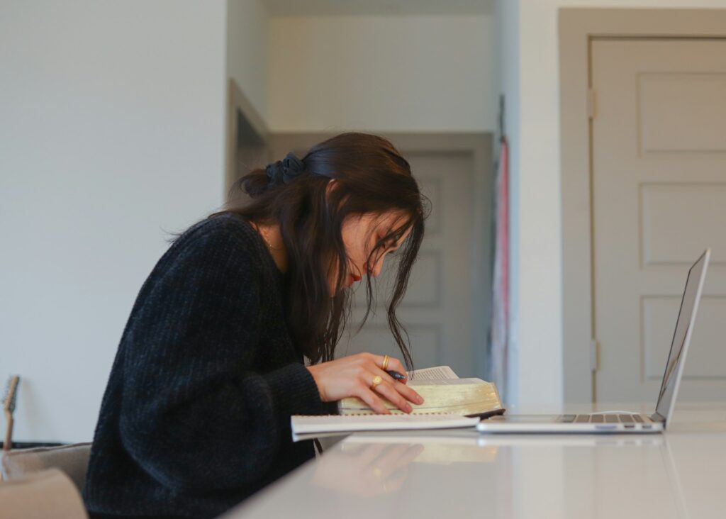 Person looking intently at documents on a desk